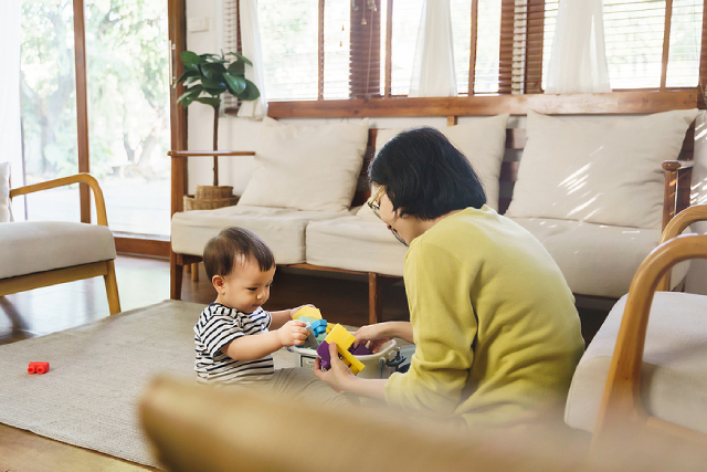 A confinement nanny playing with a toddler