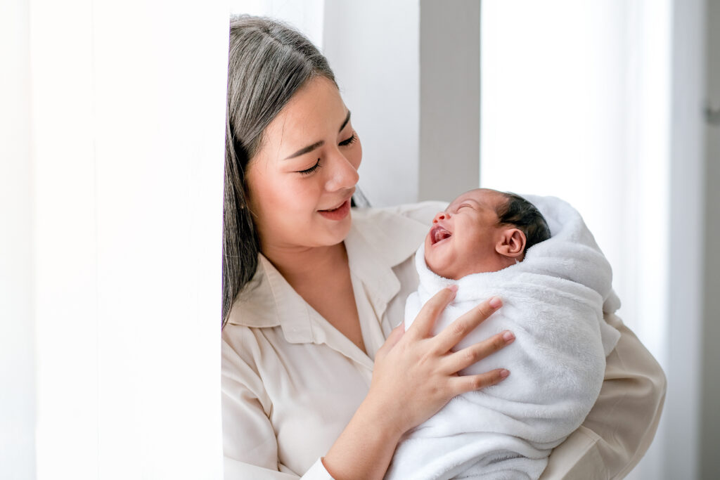 a mother looking at her newly born child