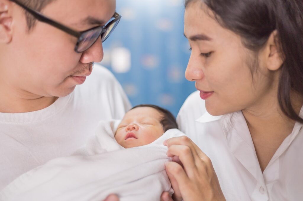 parents looking at their newly born child