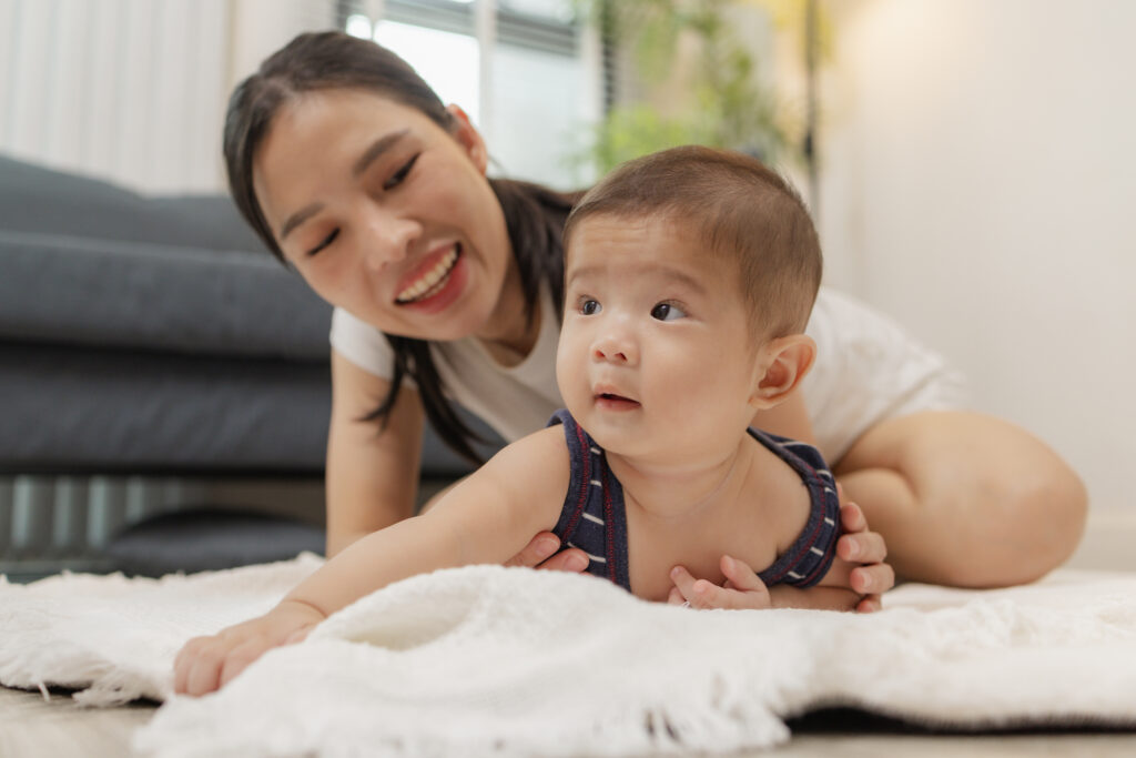 part time or day time nanny in singapore happily taking care of a baby