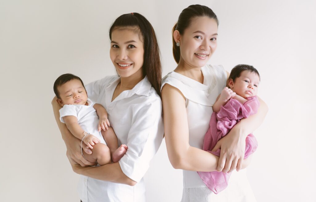 two confinement nannies holding babies
