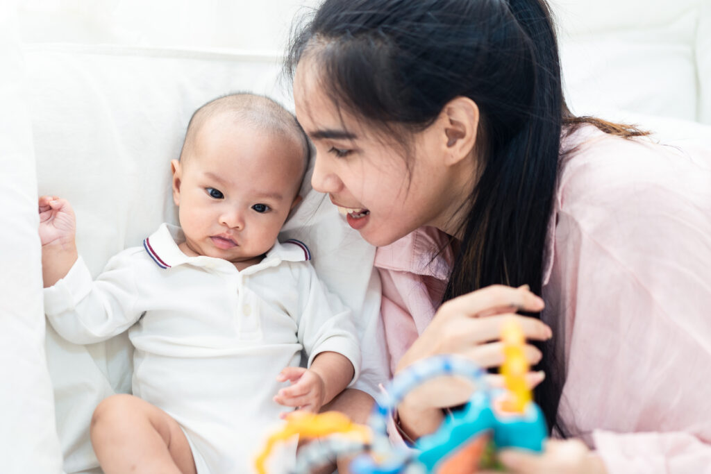 Caregiver engaging with a baby during a nurturing home care session in Singapore.